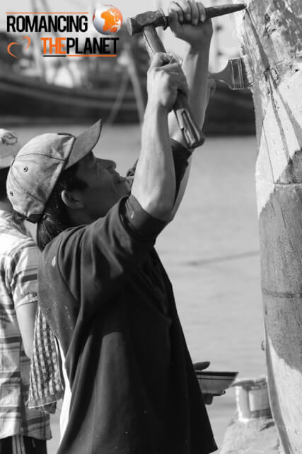 Carpenter doing the wook work on a shipping boat in Ninh Hoa, Vietnam
