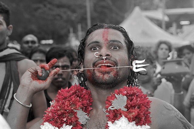 A devotee piercing his tongue during Thaipusam festival