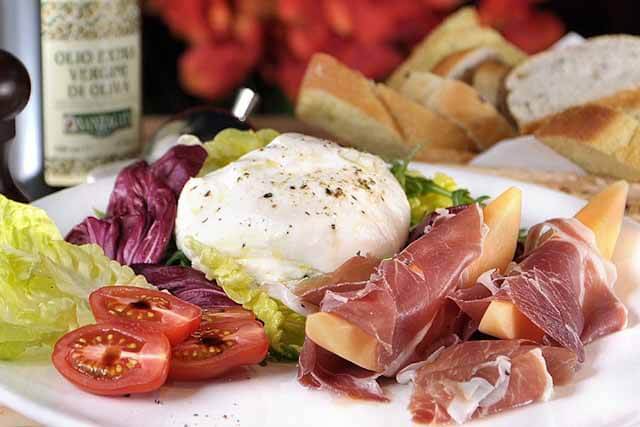 Burrata Pugliese which is a made from fresh Buratta Cheese, Mixed Salad, Parma Ham and Melon